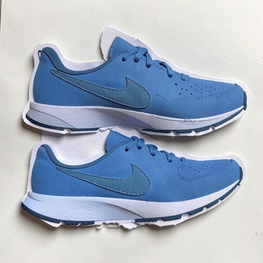 Layered paper cutout of blue running shoes on cream background
