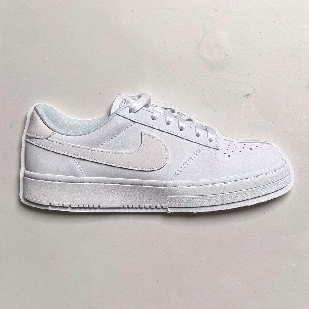 Layered paper cutout of a low profile casual sneaker in soft beige and white tones
