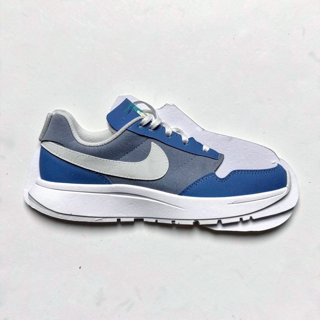 Layered paper cutout of dark blue performance running shoes with subtle accents