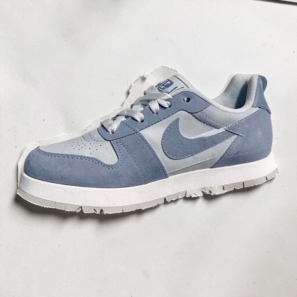 Layered paper cutout of dark blue running shoes in motion pose