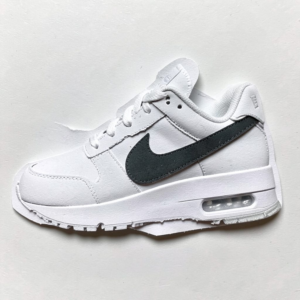 Layered paper cutout of performance running shoes in dark blue and gray